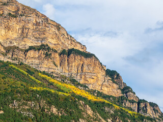 Beautiful mountain landscape with red rounded rocks. Big rock formation, different rock formations and soil layers. Distant mountain plateau. North Ossetia.