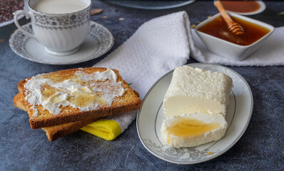 Clotted cream (butter cream) for Turkish breakfast - Kaymak, honey and glass of milk