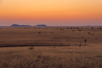 Fototapeta na wymiar Sunset over the savannah. Beautiful landscape. Solitaire, Namibia.
