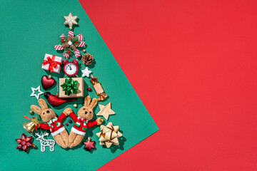 Silhouette of Christmas tree made of toys on green background. Merry Christmas and Happy New Year concept