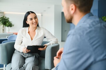 Upset man alcoholic sitting at psychologist on psychotherapy session, sad depressed addicted drunk...