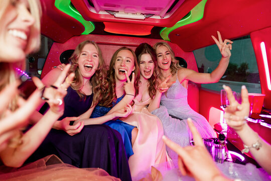 Portrait Happy Teenage Girl Friends Celebrating In Prom Limousine