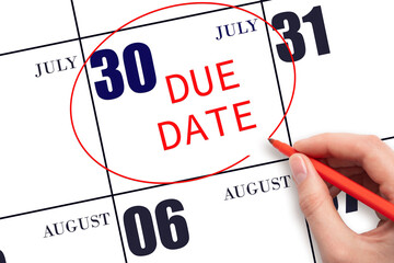 Hand writing text DUE DATE on calendar date July 30 and circling it. Payment due date
