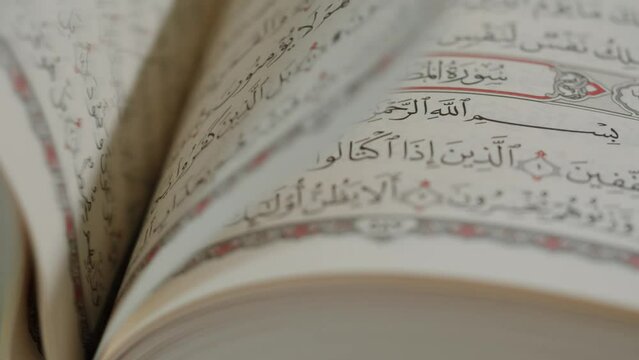 The Holy Quran Book, koran Chapter, flipping pages Close up Macro.