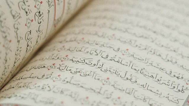 The Holy Quran Book, koran Chapter, flipping pages Close up Macro.