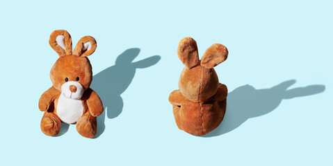 Soft toy bunny on blue pastel background