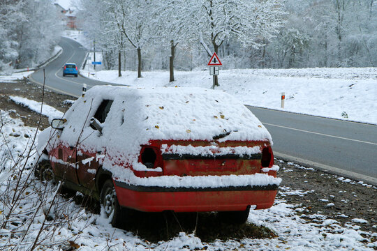 Abandoned car standing by the road. Maybe after the traffic accident or failure. Symbolises also the dangerous conditions in winter with ice, snow and snatch. 