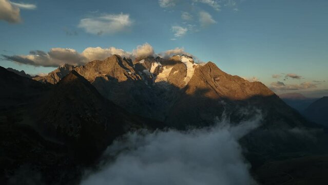 sunrise on rocky mountains with snow french alps ecrins massif aerial view over clouds