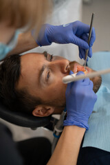 Young man at the dentist. Dentist woman. Dental office.