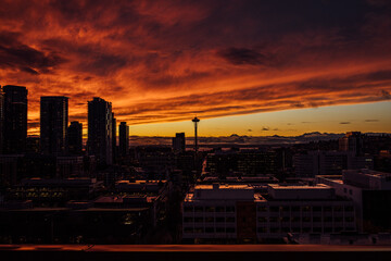 dramatic red, orange, dark winter sunset with Seattle skyline 