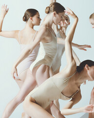 Group of young women, ballerinas dancing, performing isolated over grey studio background. Expression of grace - obrazy, fototapety, plakaty