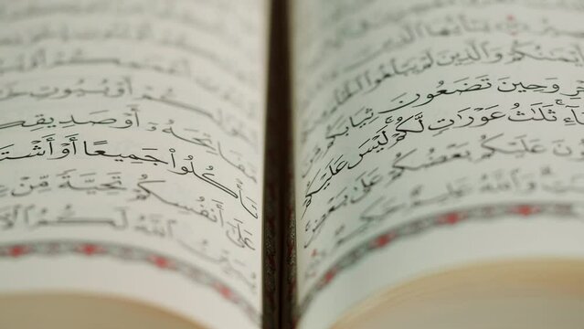 The Holy Quran Book, koran Chapter, flipping pages Close up Macro.