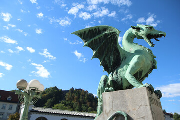 Dragon statue standing on the Dragon bridge in Ljubljana in Slovenia during the nice and sunny day. 
