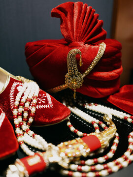 Sehra for groom in traditional Indian wedding ceremony near groom`s red shoes