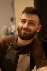 Fototapeta premium Young handsome barista with red beard, portrait, close-up.