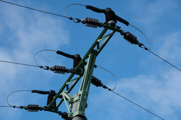 The close up of electricity power cable on steal pole on sunny day with bright blue sky as a...