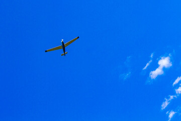 Airplane flying in blue sky with clouds in Germany.