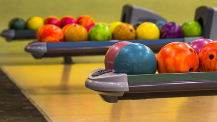 Bowling balls in the ball return machine. Selective focus on the front balls. Shallow depth of field.
