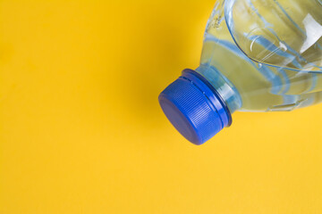 Plastic water bottle on yellow