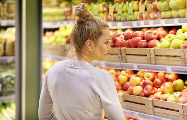 Woman buying fruits and vegetables at the market