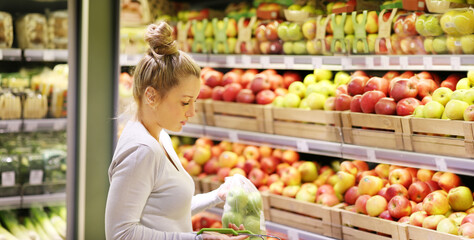 Woman buying fruits and vegetables at the market