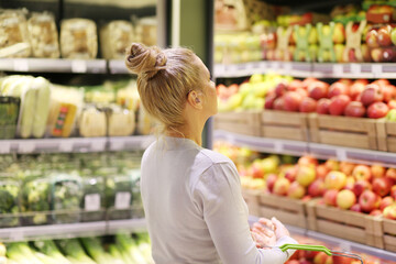 Woman buying fruits and vegetables at the market