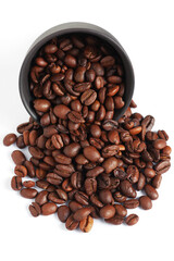 Coffee beans spill out of a bowl