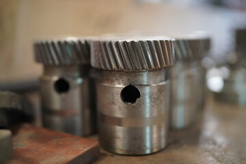 Close up on parts of industrial machines in large garage or workshop