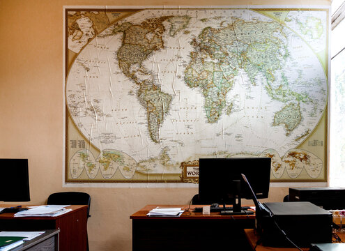 A fragment of an office room with a large map of the world