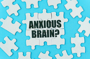 On a blue background are white puzzles with the inscription - anxious brain