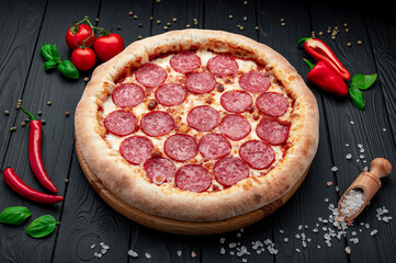 Tasty pepperoni pizza and cooking ingredients tomatoes basil