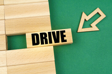 On the green surface are wooden plates and an arrow that points to a plate with the inscription - drive