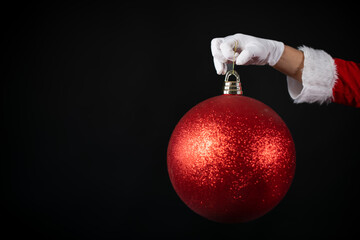 Weihnachtlicher Hintergrund mit Platzhalter. Die Hand vom Weihnachtsmann hält eine riesige...