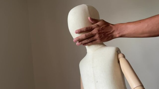 Creepy male hand touching, groping and cover mouth child mannequin body. Child abuse concept. Young children victim of domestic violence.