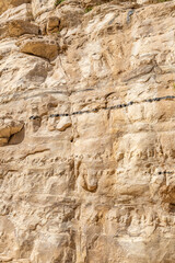 Ein Avdat  rocks of Eocene white limestone bearing thin seams  of black brown flint in southern Israel.
