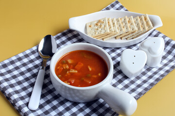 Alphabet soup served with saltine crackers.