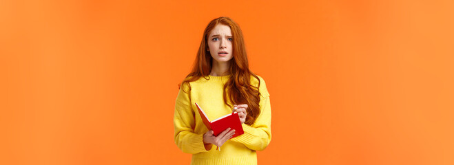 Concerned tensed attractive redhead female student cant write down everything from blackboard after...