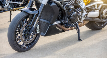 Black motorcycle on the running board parked.