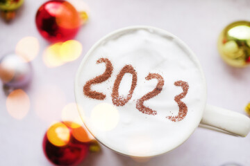 2023 on cup of coffee top view. New Year resolution. Winter holidays cozy 