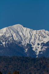 snowy mountain photo with blue sky background
