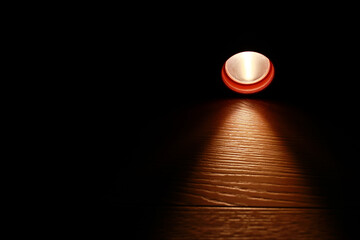 Flashlight and a beam of light in darkness. A modern led light with bright projection on dark wood...