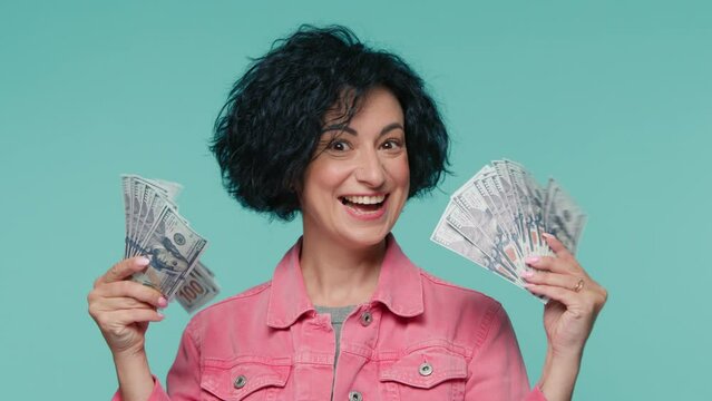 Amazed mature business woman executive worker. Curly female investor rejoice getting real payment dollars currency. Win lottery cash prize profit receiving money bonus work salary surprised wow effect