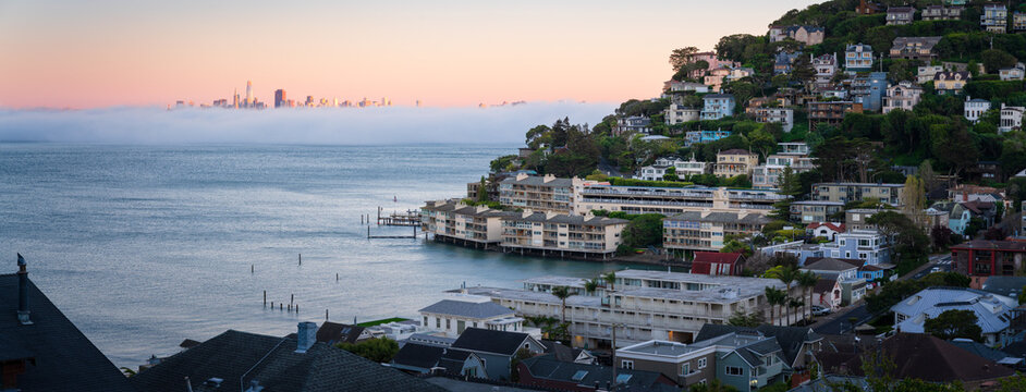 Fog drifts over the bay in front of the San Francisco skyline, as we enjoy a beautiful sunset from Sausalito, California