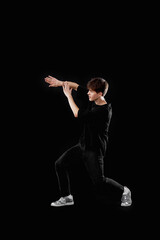 Fototapeta na wymiar young man in black t-shirt and jeans dancing