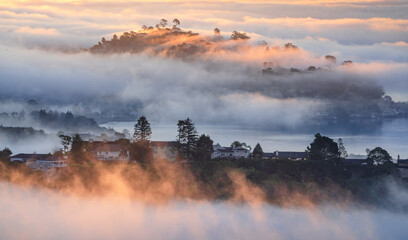 Layers of fog, islands, and peninsulas dotted with beautiful homes, photographed from Tiburon, California.