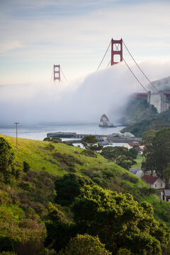 Golden Gate Bridge towering over the hills of Cavallo Point and Fort Baker, in Marin County, California