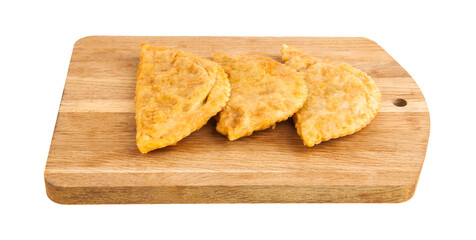 Chebureks on a wooden board isolated on a white background.