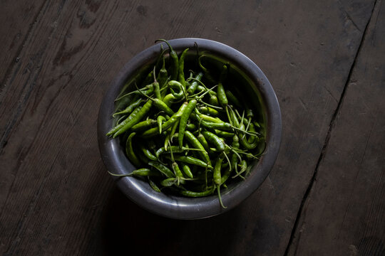 Bowl full of green chili peppers ready to prepare a pickel. Langtang National Park. Nepal.
