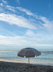 Seascape in Waikiki Hawaii of a Deserted Beach with an Umbrella.