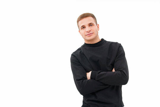 a man in black clothes with his arms crossed on his chest on a white background.